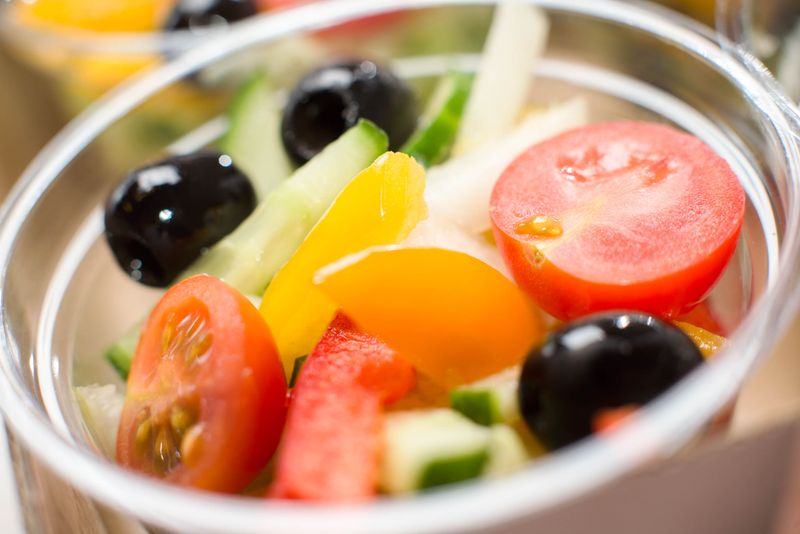 Italian chopped salad with fresh vegetables and olives